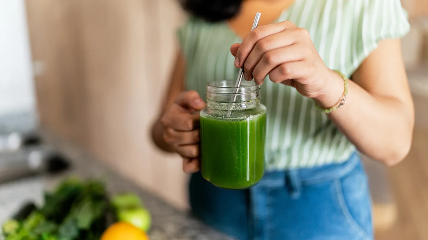 woman drinking celery juice
