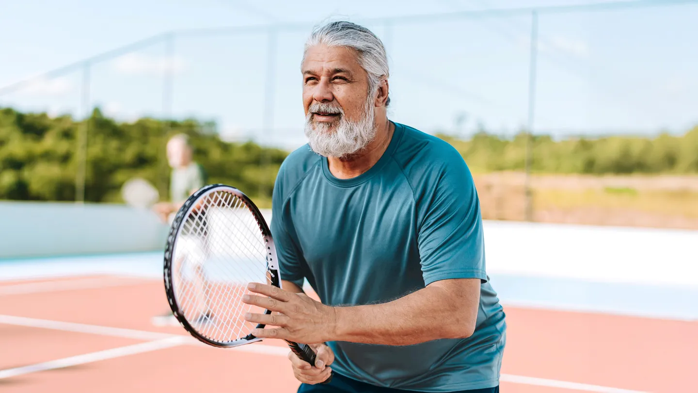 Mature man playing tennis