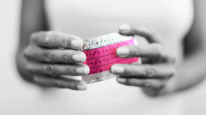 woman holding pill pack hormone replacement therapy