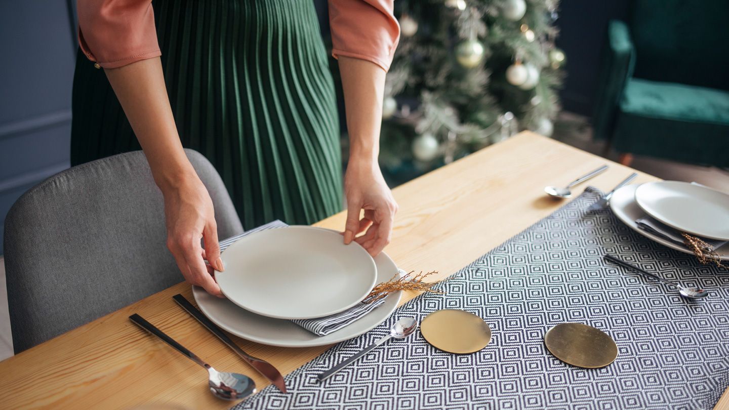 woman setting up holiday dinner