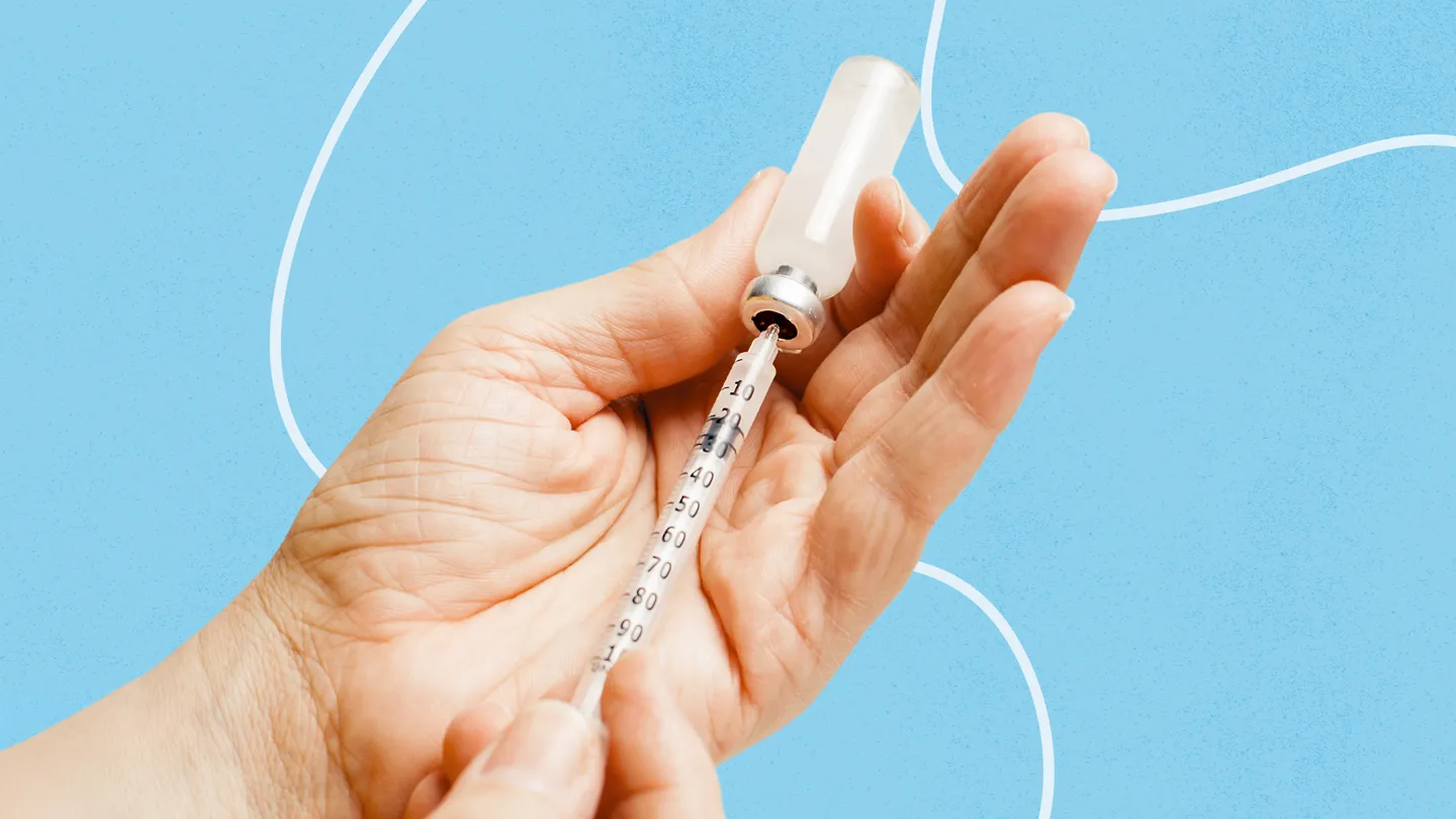 hands holding a medical vial and syringe