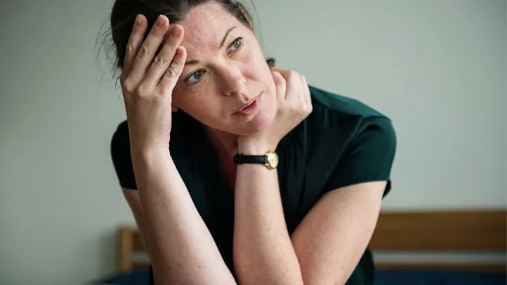 a woman experiencing the emotional toll of having bedbugs