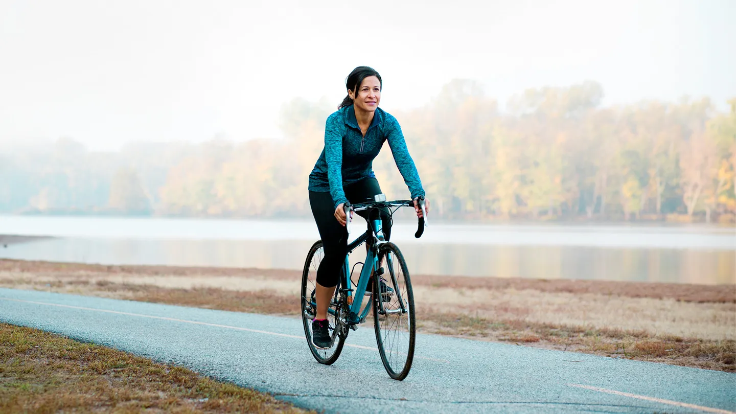 woman riding bike outside cycling