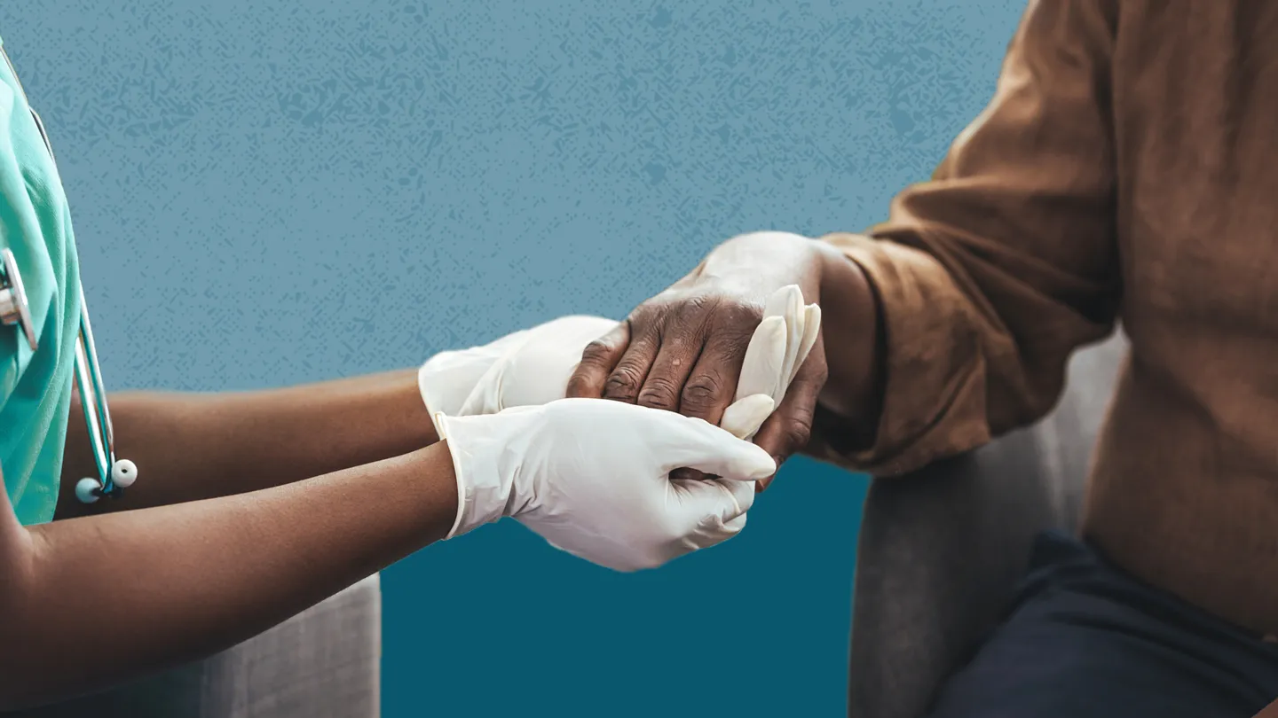 doctor looking at Black man's hands melanoma