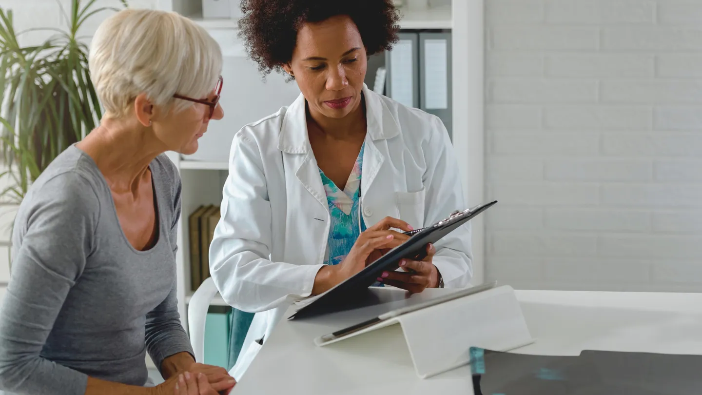 mature woman discussing treatment options with her doctor