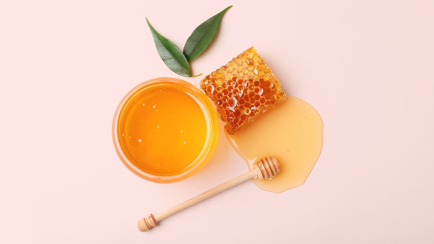 honey in a jar next to honeycomb