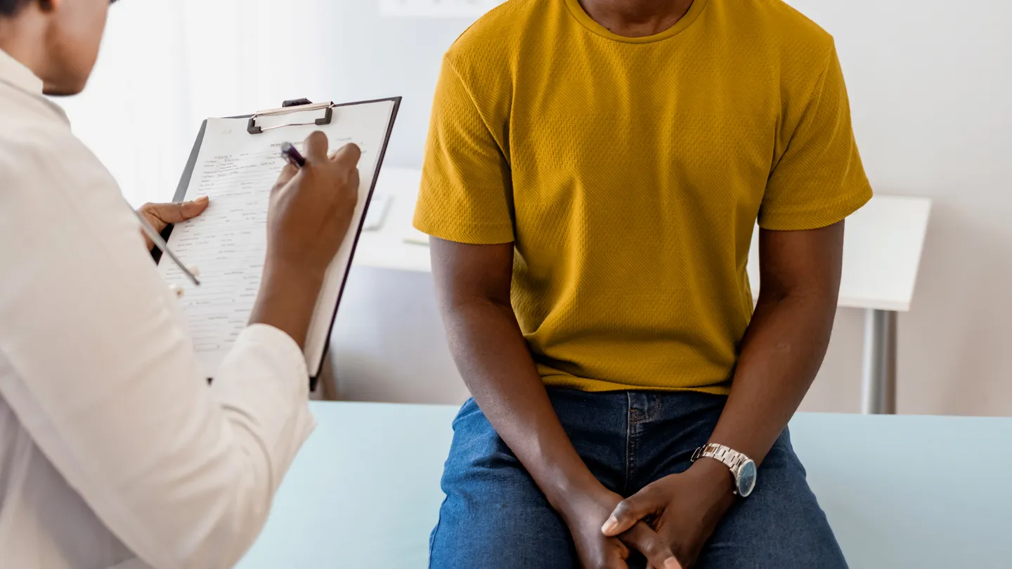 Black man talking with his doctor about treatment options