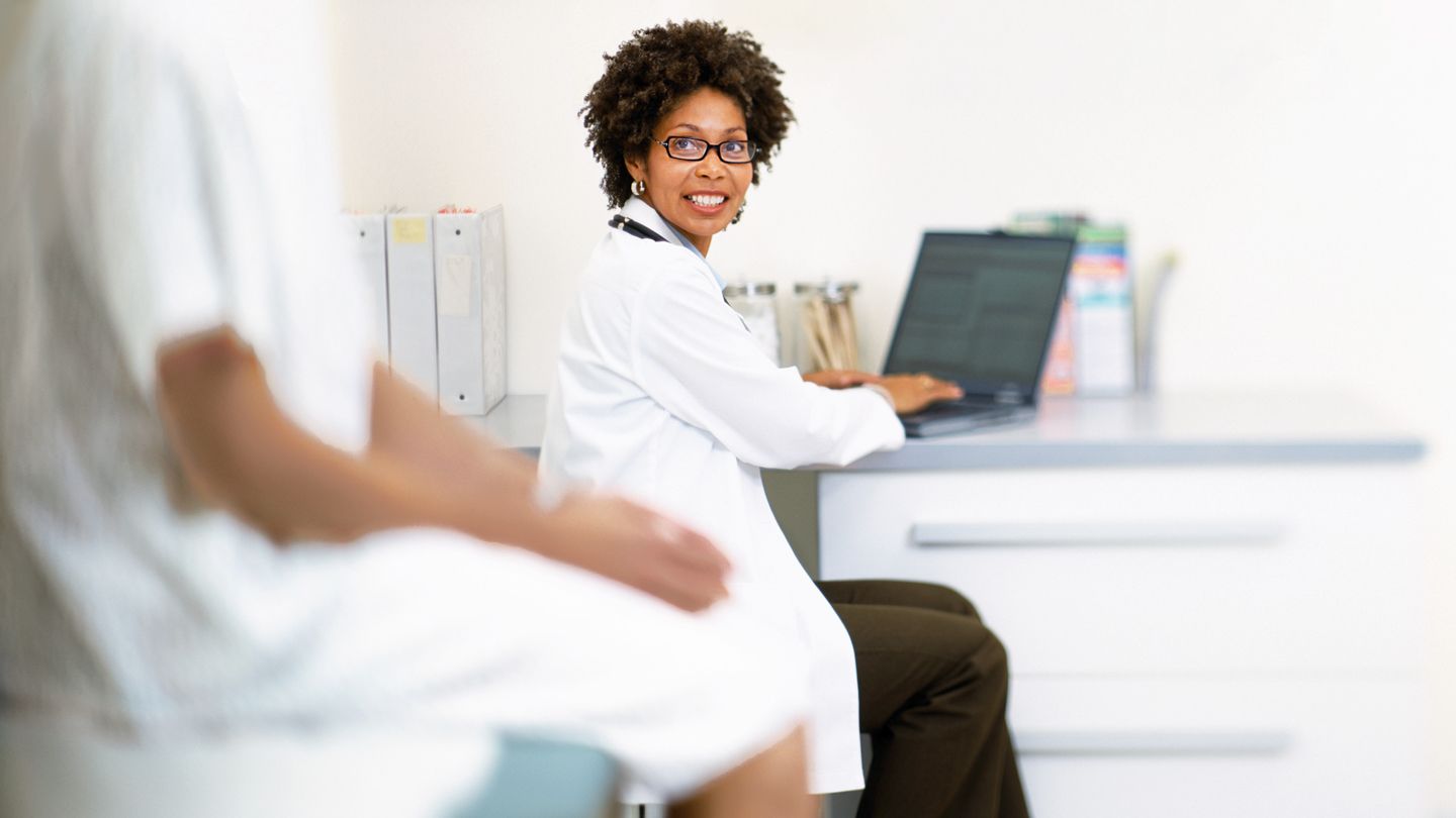 Black female doctor with patient