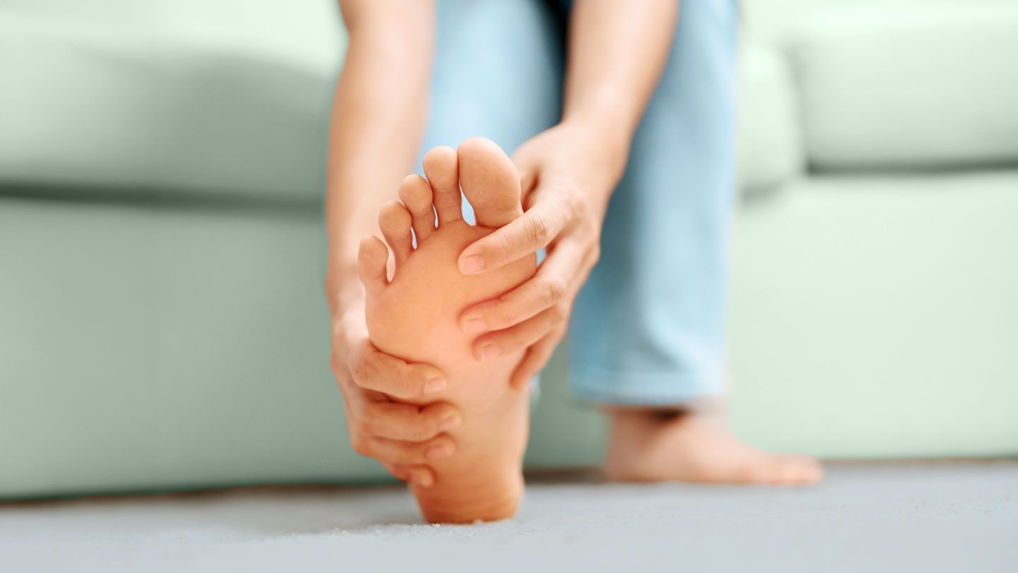 woman holding her foot