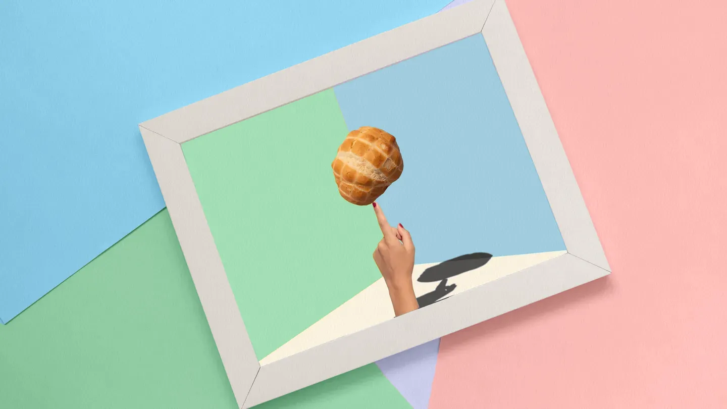 finger balancing a loaf of bread
