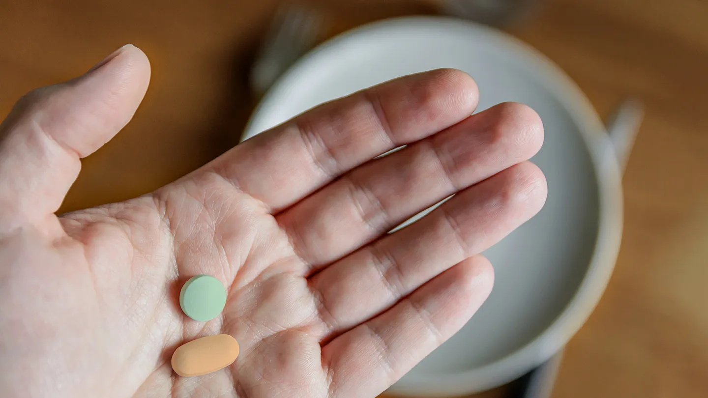 hand with digestive enzymes before meal