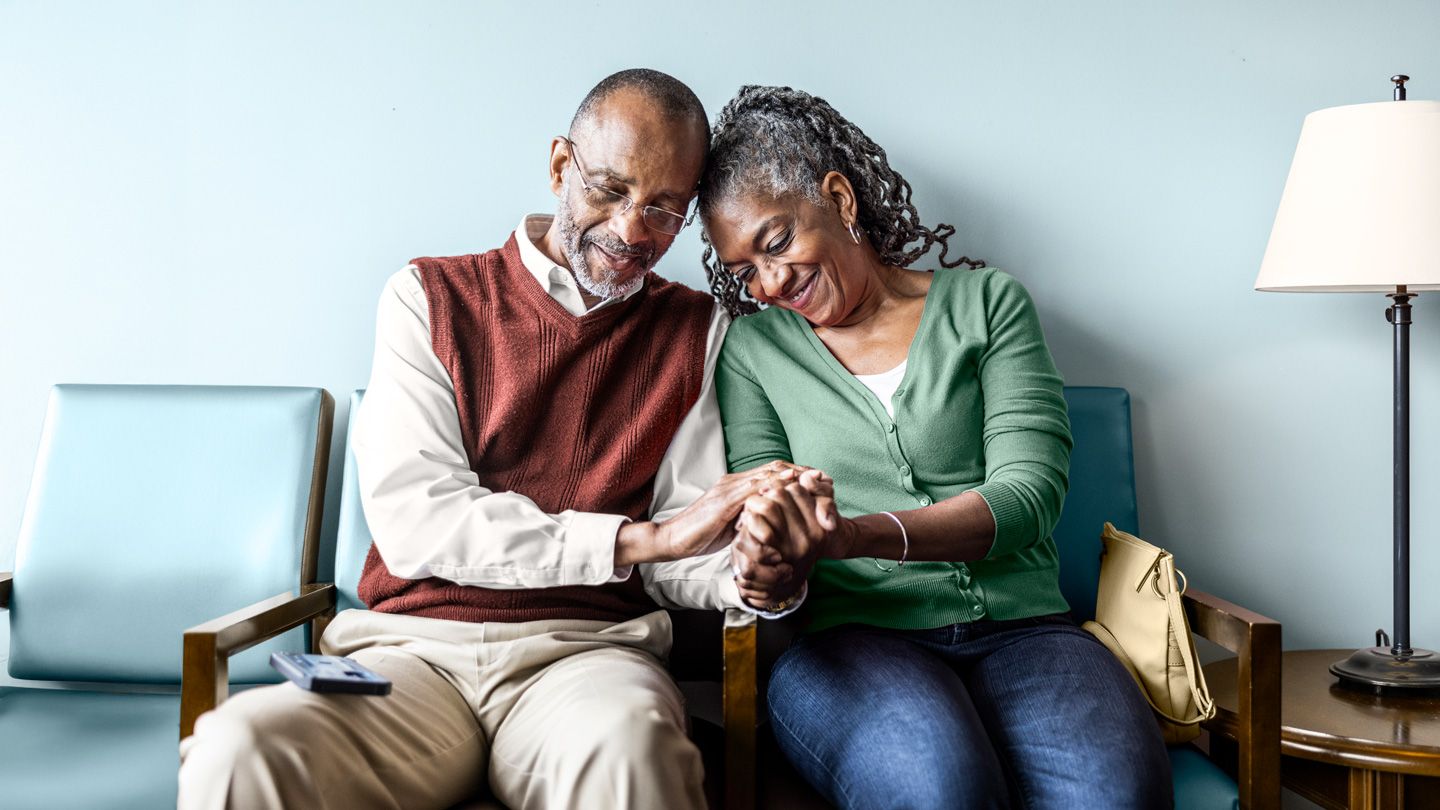 Senior couple sitting in doctor's office waiting room