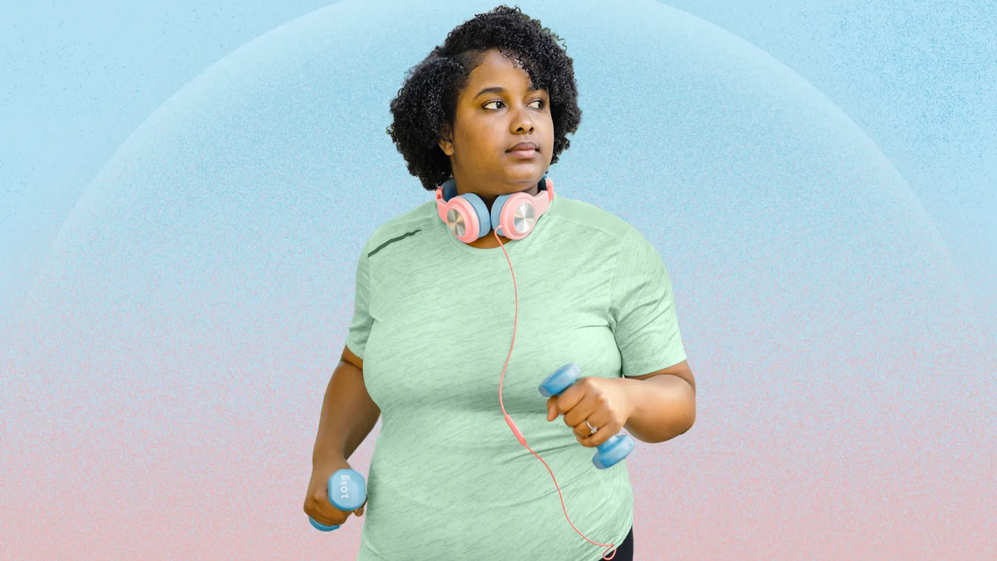 over weight woman walking with hand weights