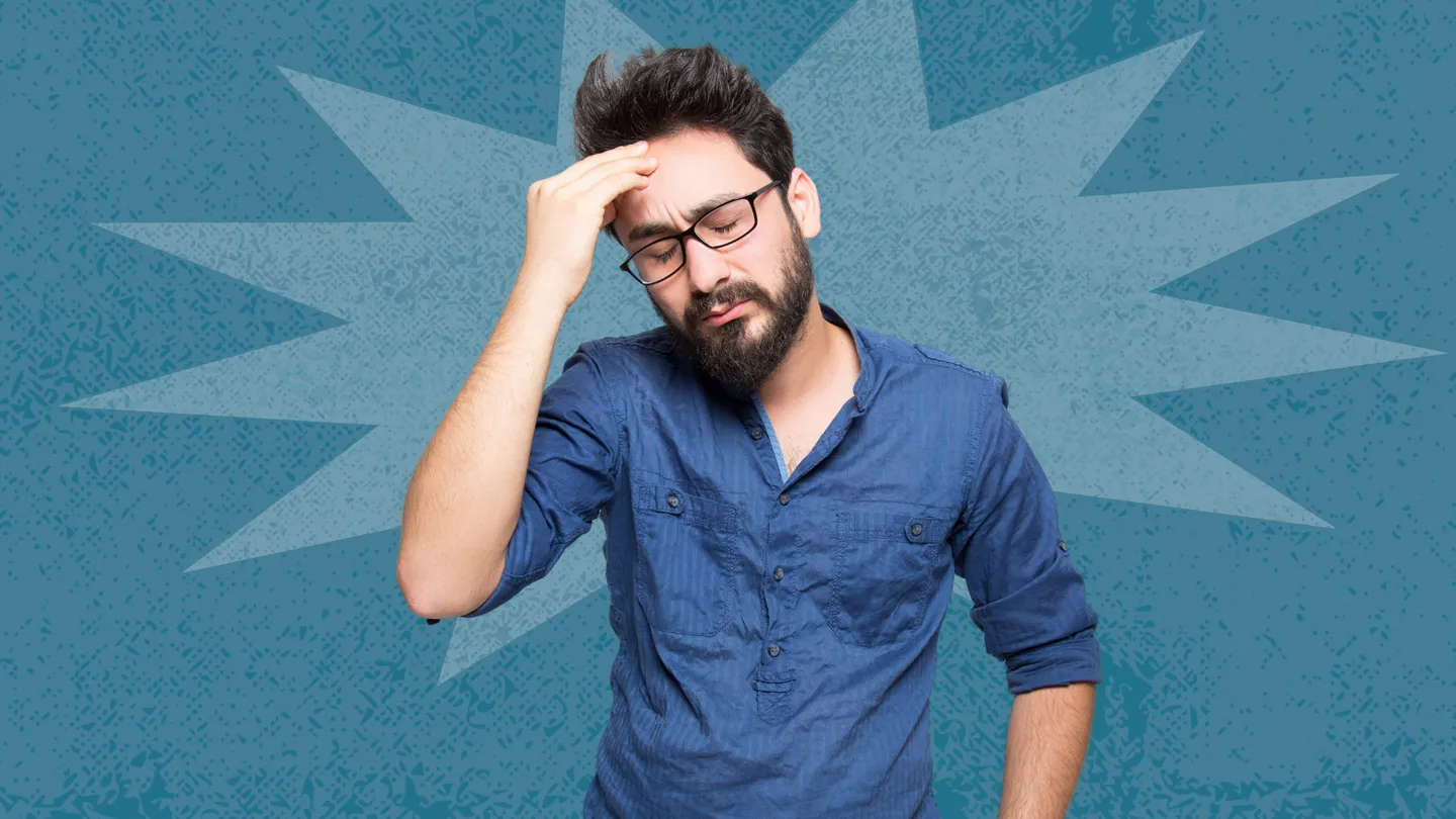 man holding his head in pain