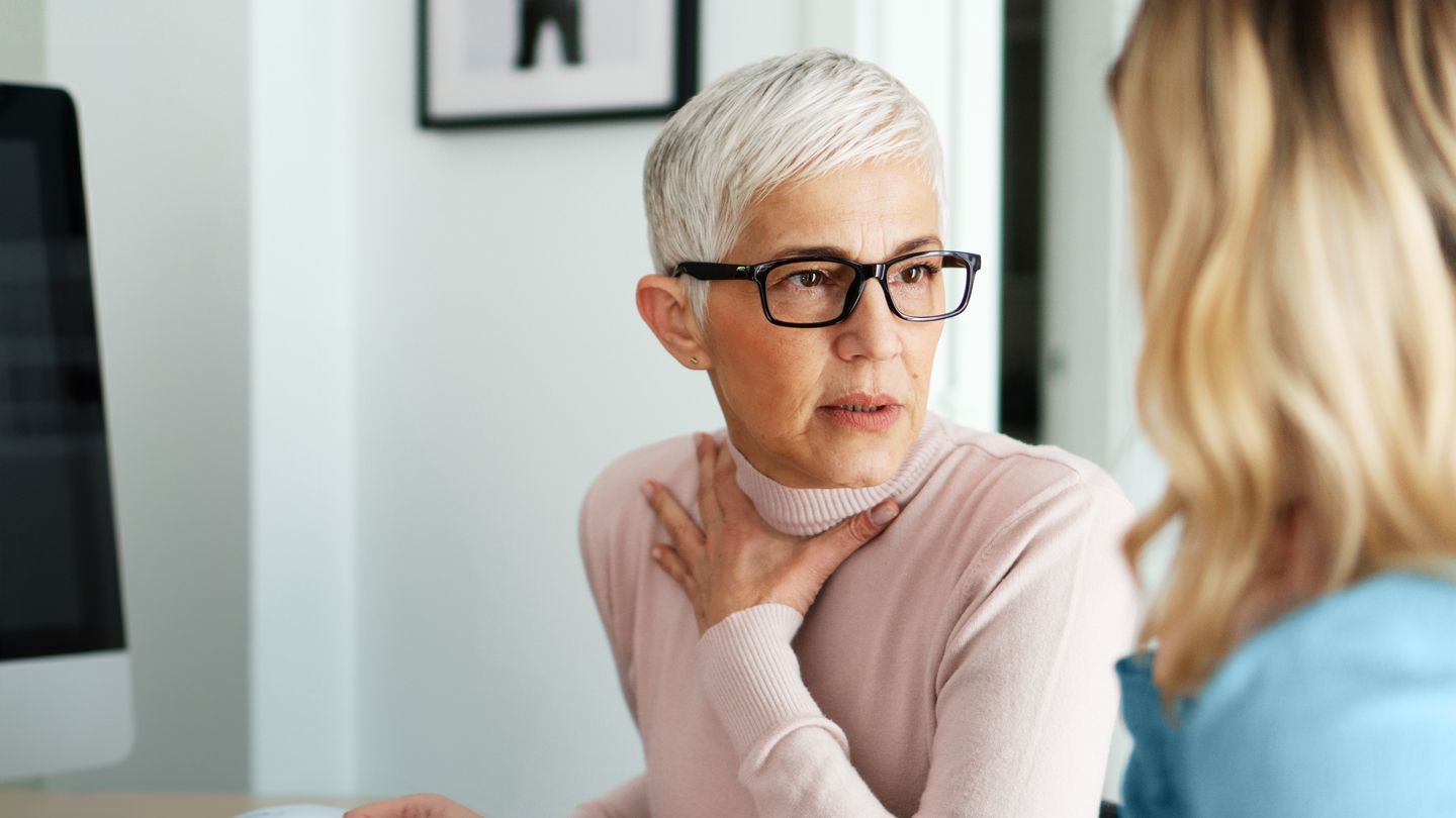 woman speaking earnestly with colleague