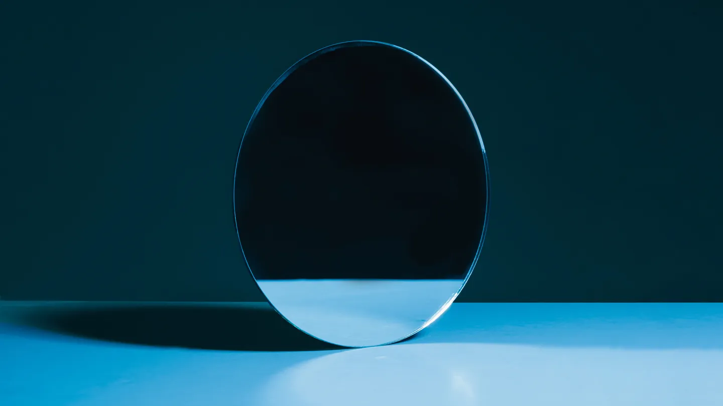 dark room circle mirror reflecting nothing concept