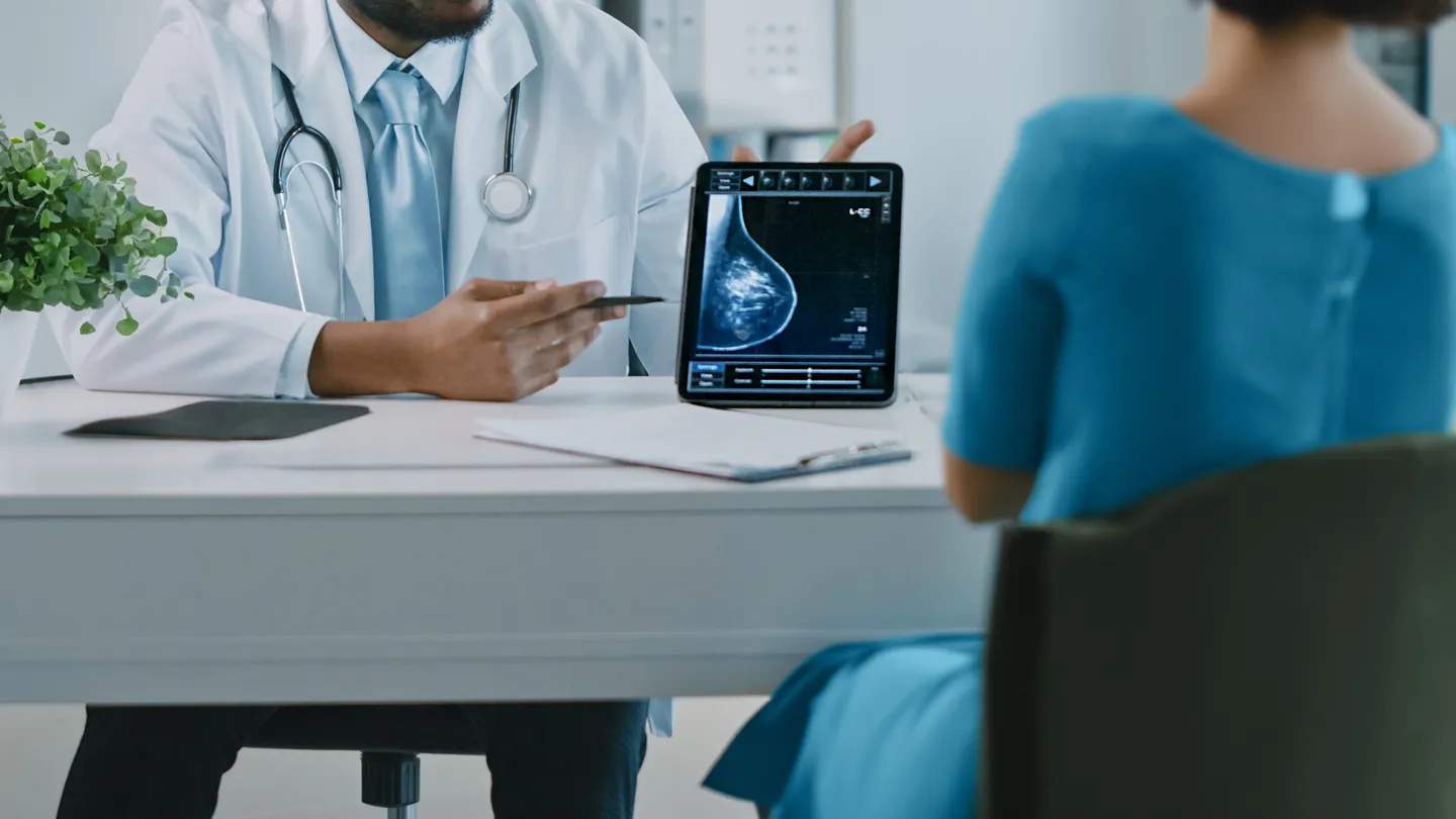 woman at oncologist's office looking a test results from mammogram