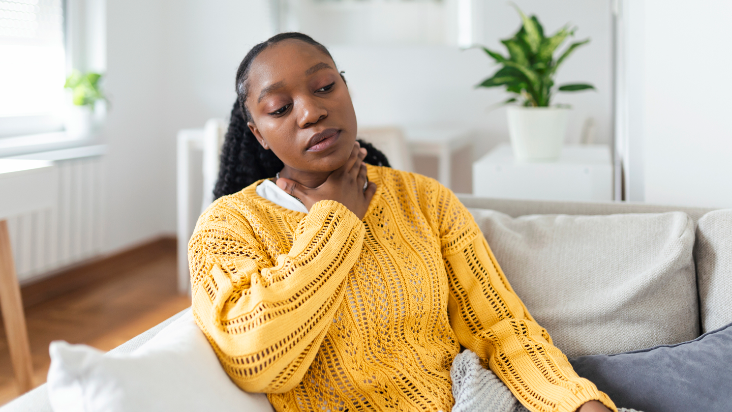 Black woman with throat pain