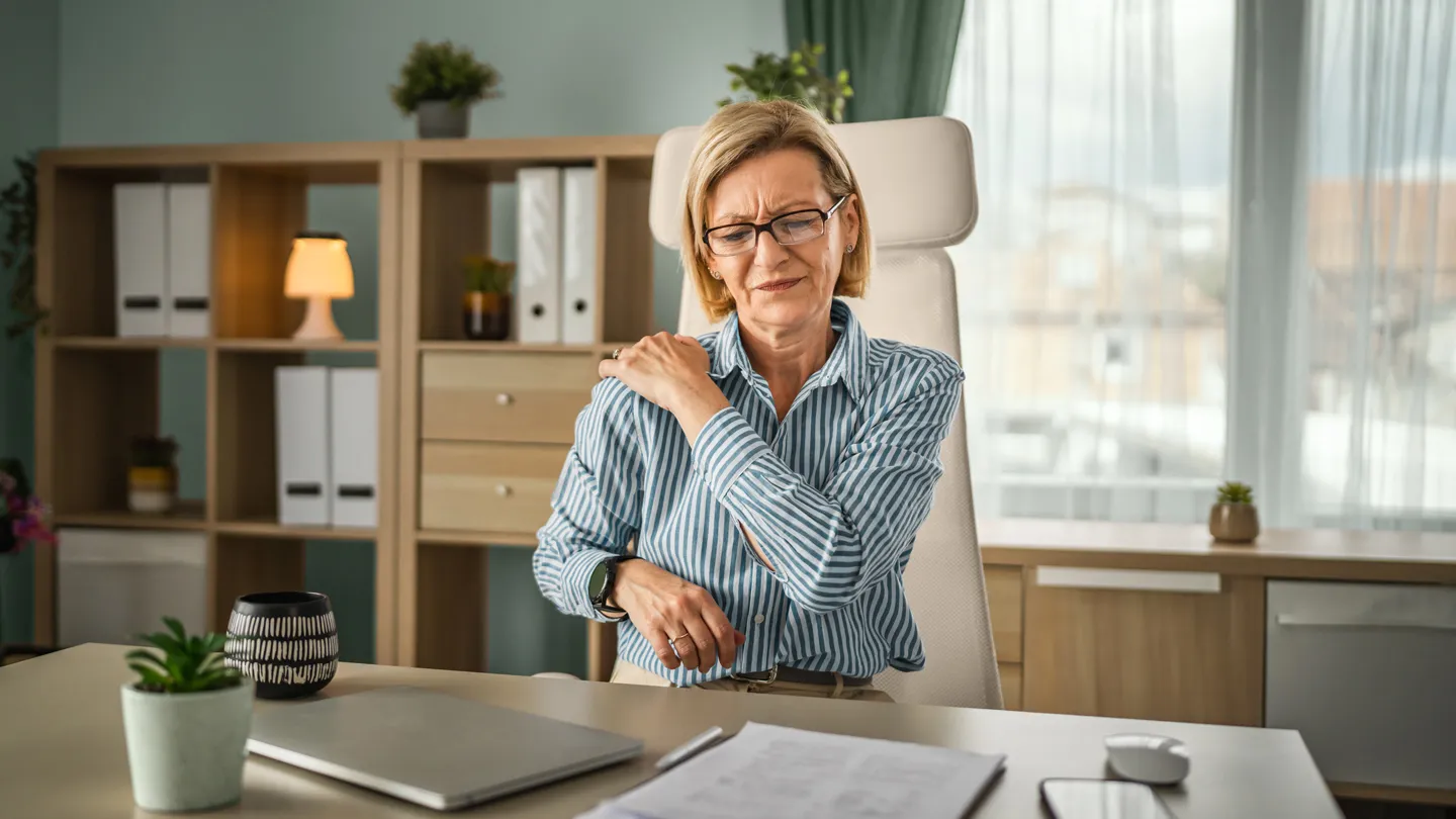 woman in pain at her desk