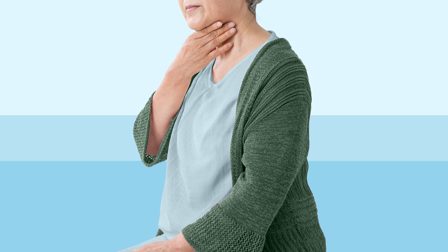 senior Asian woman holding her throat in discomfort