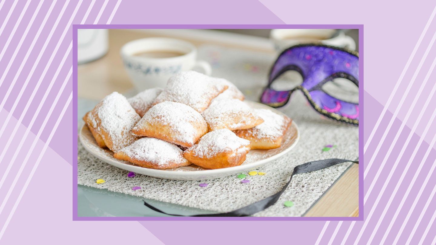beignets, coffee, and mardi gras mask on table