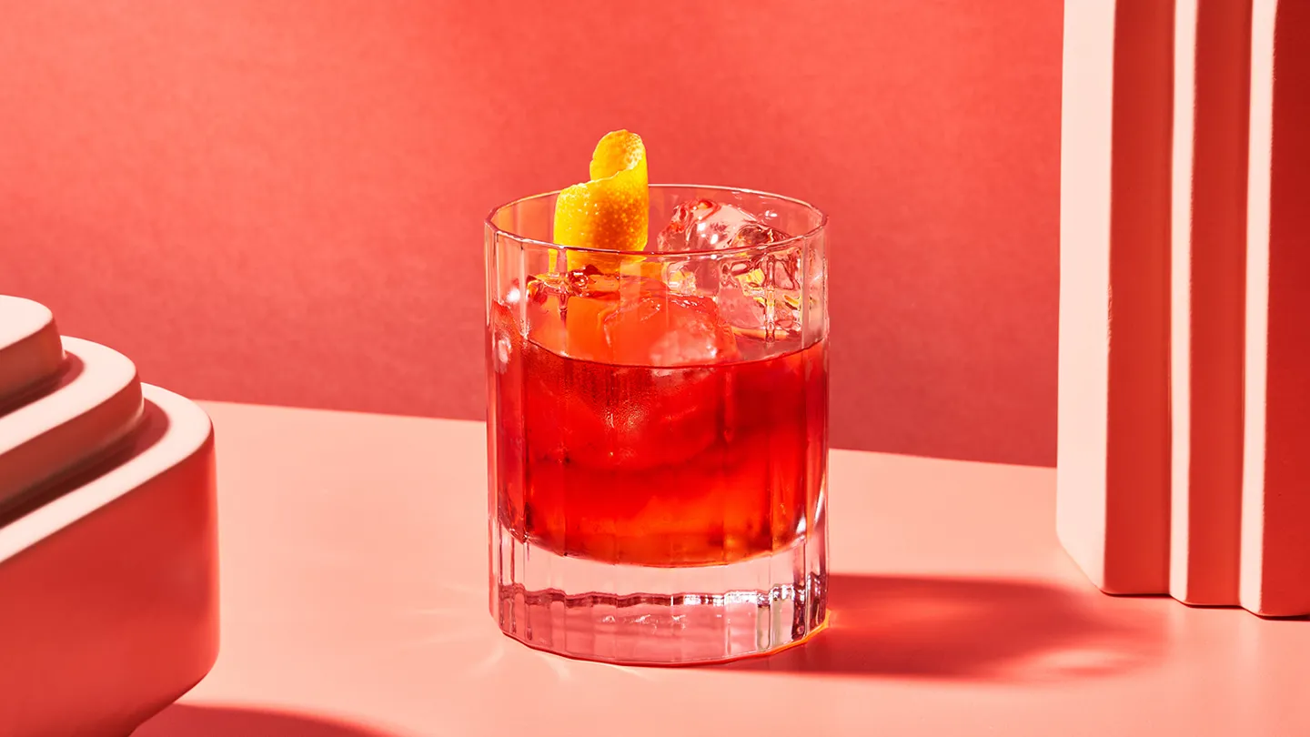 red cocktail on coral and red background