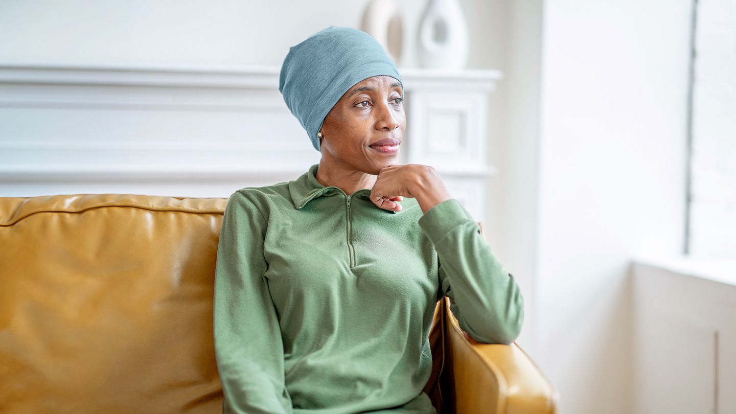 woman with cancer in thought looking out window