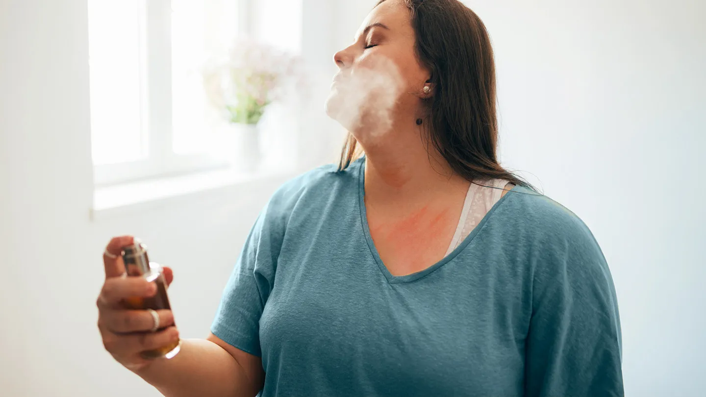woman spraying on fragrance itchy rash symptoms on neck