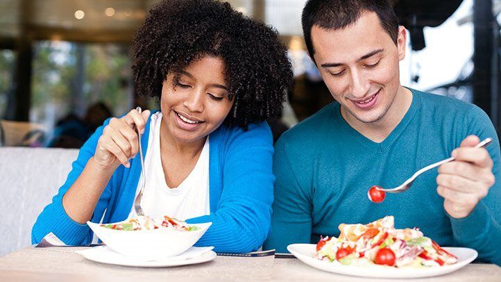 a man and woman eating food together