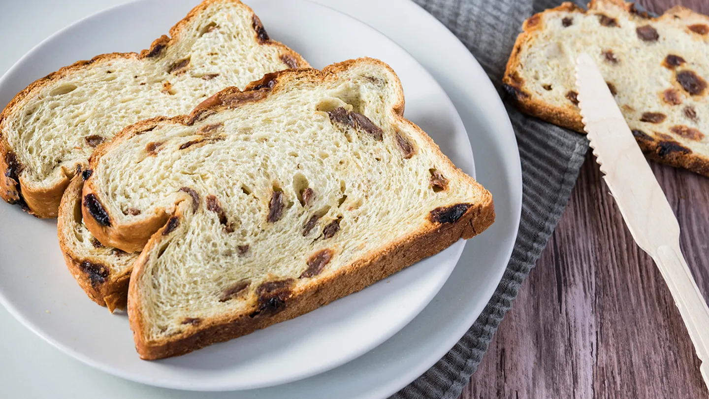 raisin bread on plate knife napkin