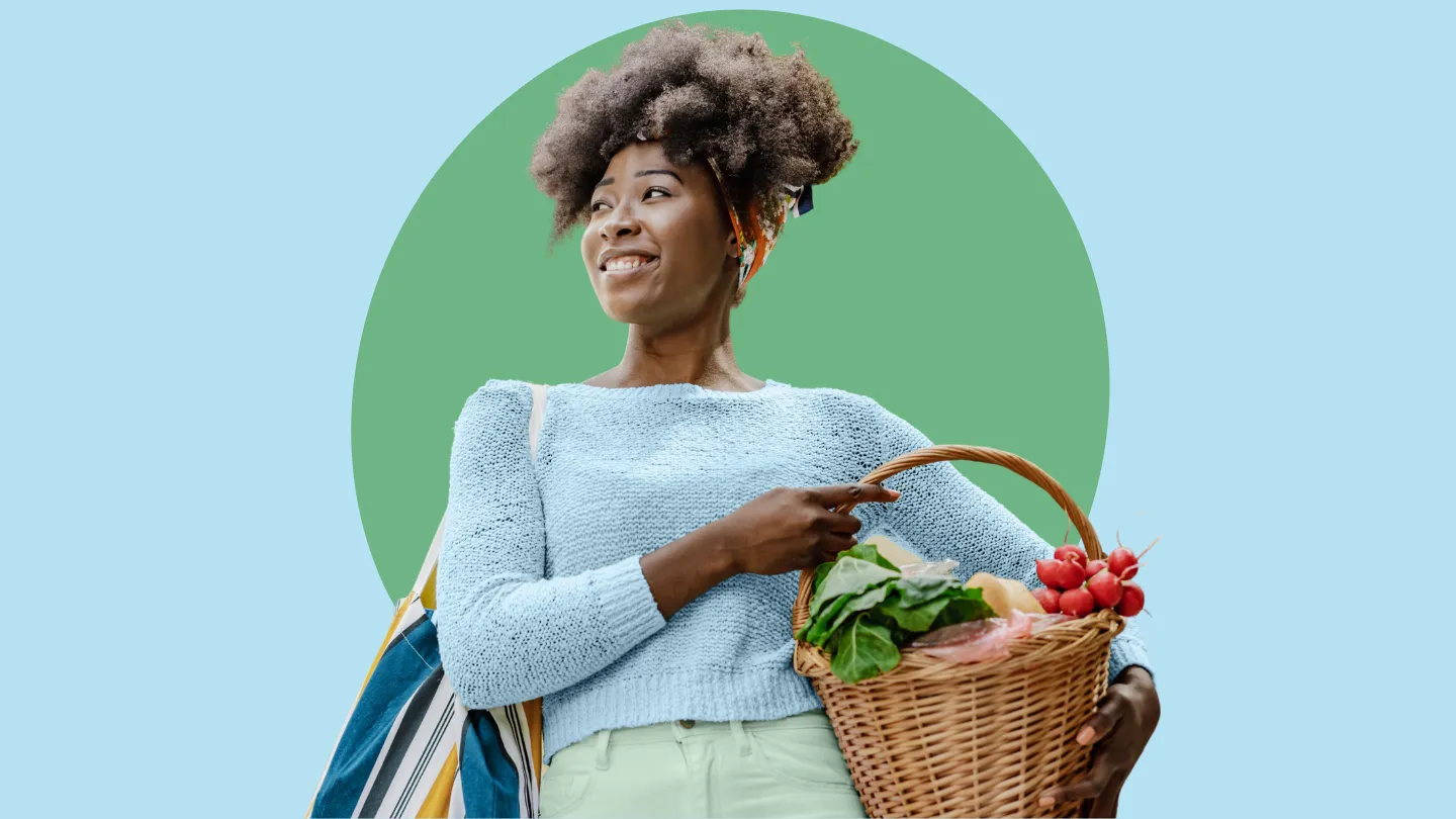 Young woman of color holding fresh produce in basket