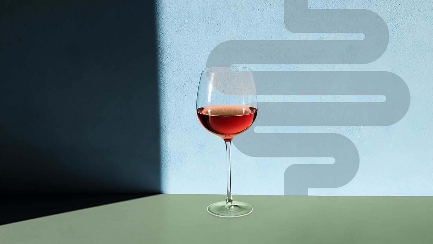 glass of wine against a wall with a shadow of intestines