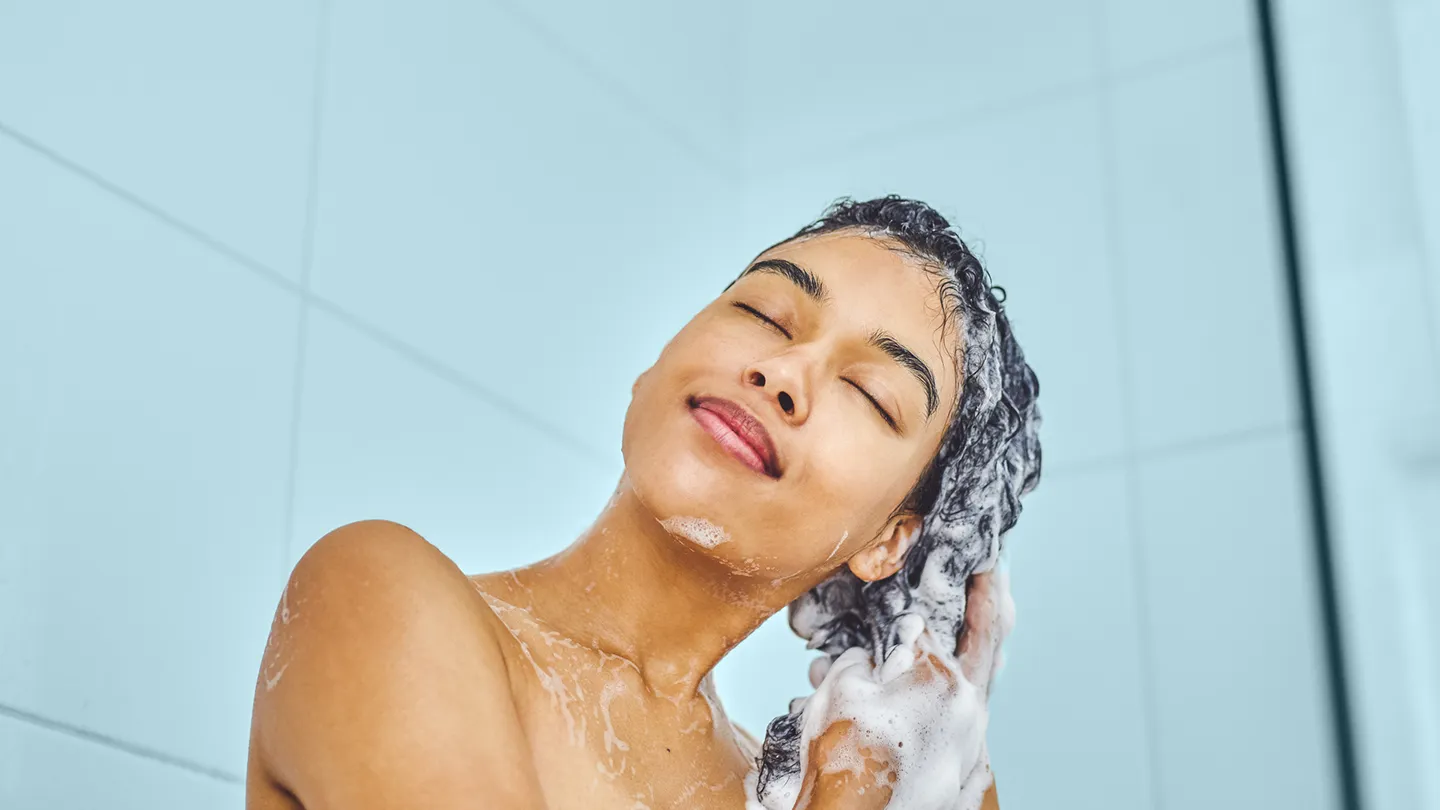 woman washing her hair in the shower