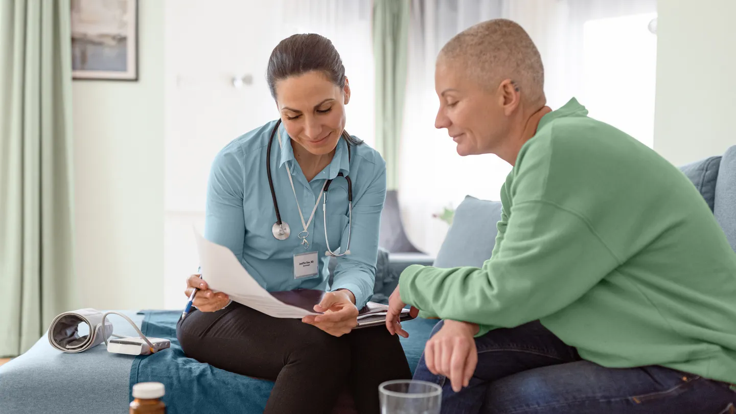 Woman cancer home session doctor discussing advanced directive
