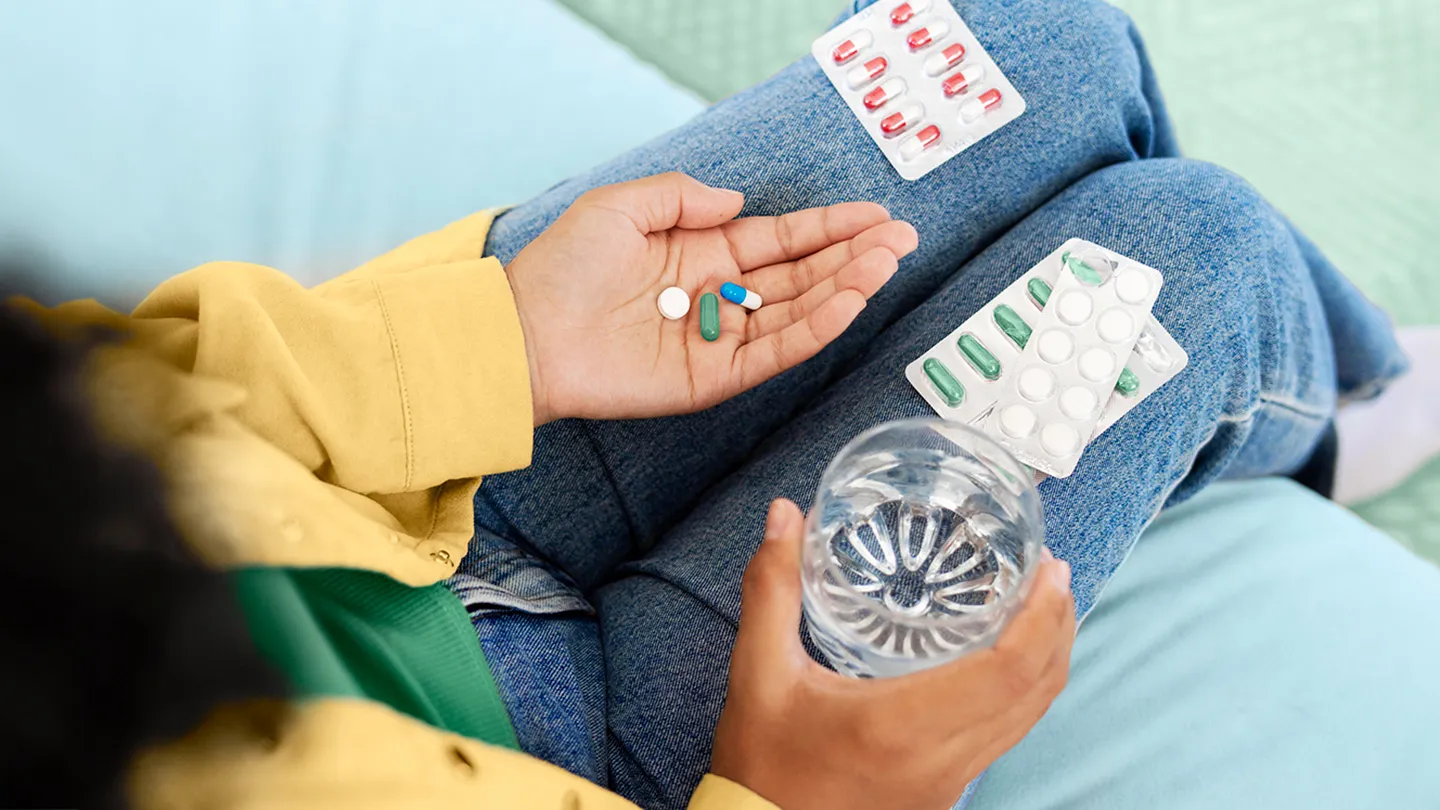 woman holding medication for chrons anti inflammatory pain relieving and supplements