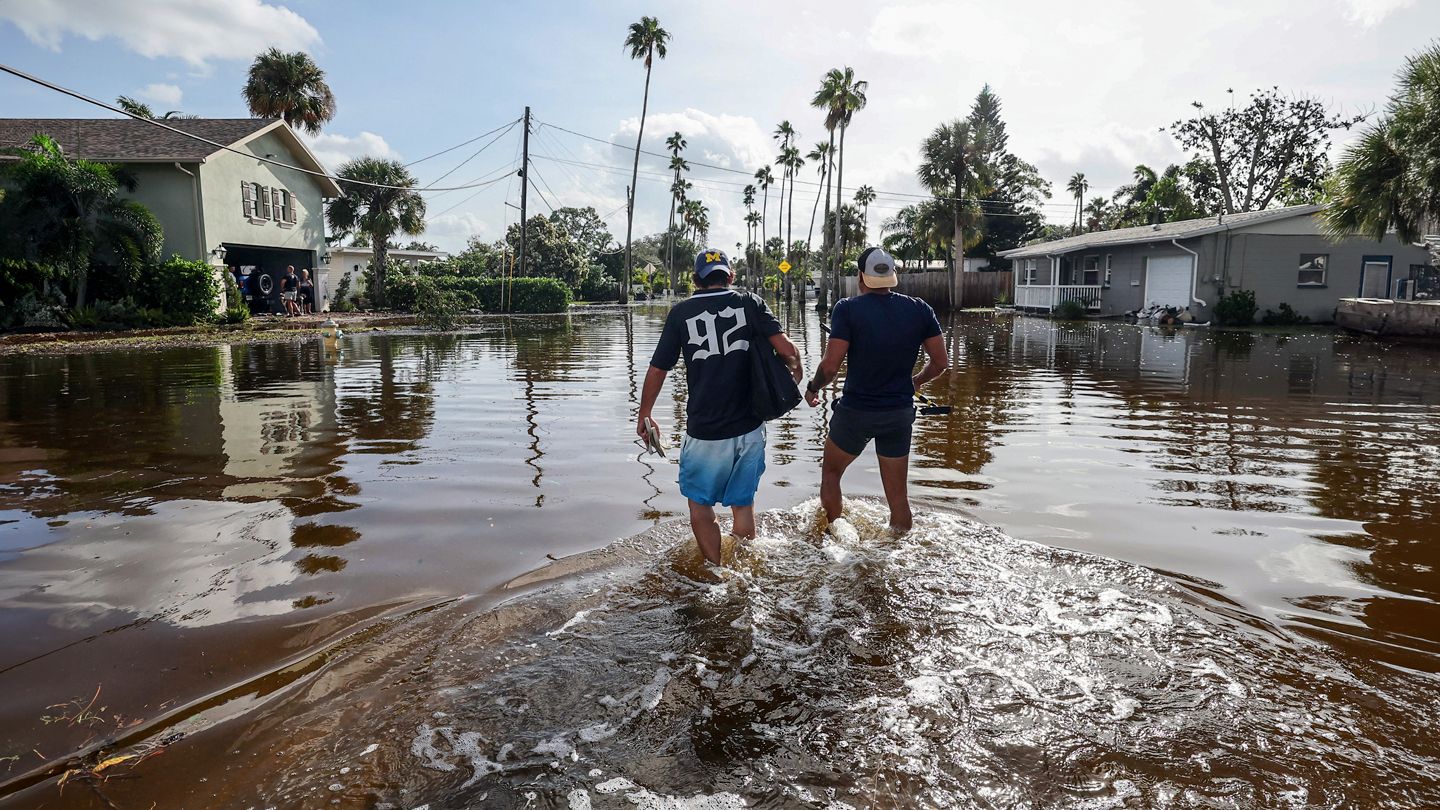 walking through the floodwaters from Hurricane Helene in St. Petersburg, Florida