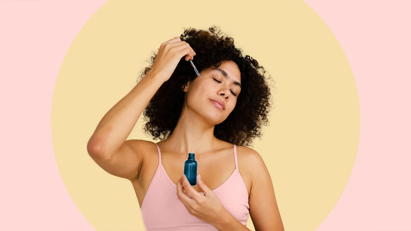 woman applying hyaluronic acid serum to face with dropper skin care