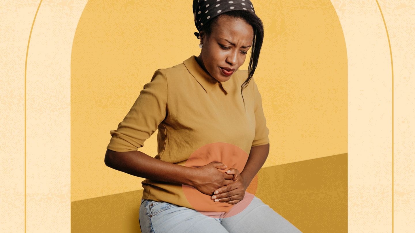 black woman in pain holding abdoben