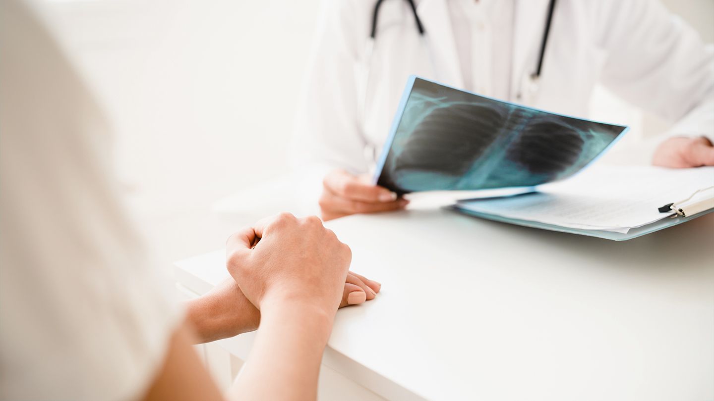 woman talking about a positive lung chest scan with doctor