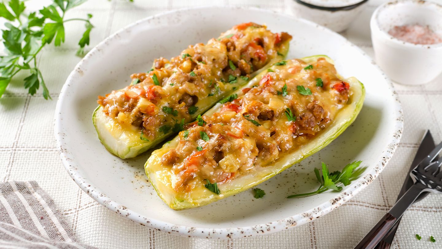 zucchini stuffed with ground beef, vegetables, and cheese