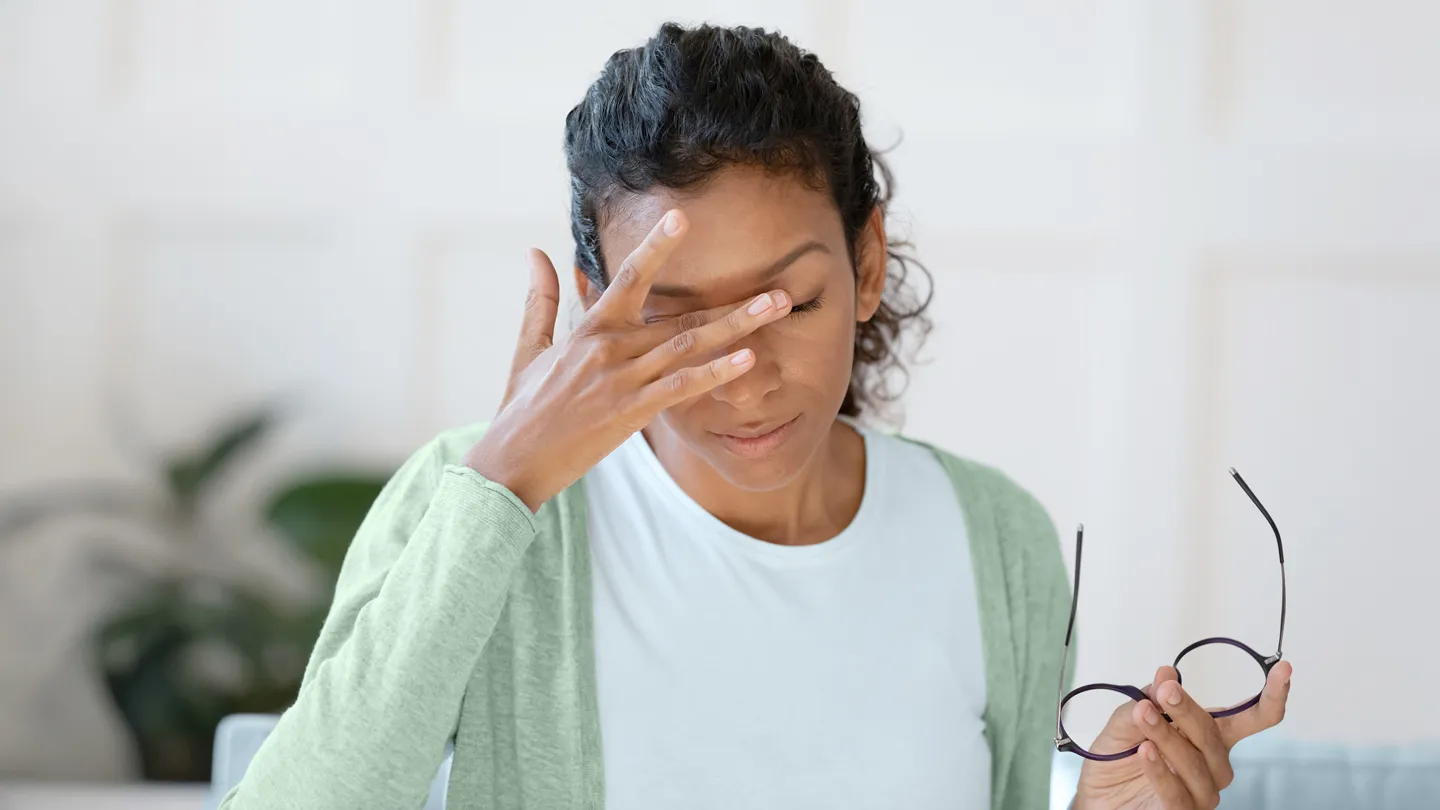 woman touching her eyes in pain