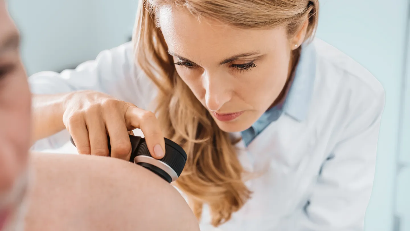 dermatologist examining patient's skin cancer