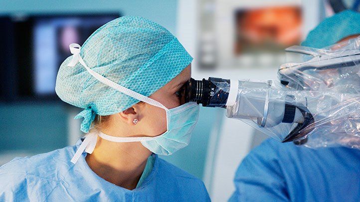 doctor looking at skin cells for melanoma