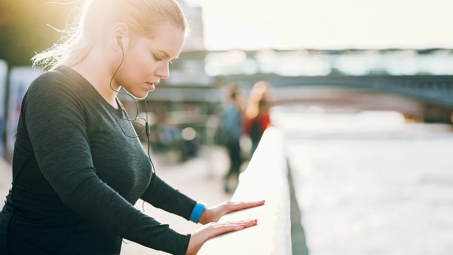 a woman with diabetes outside preparing to exercise 