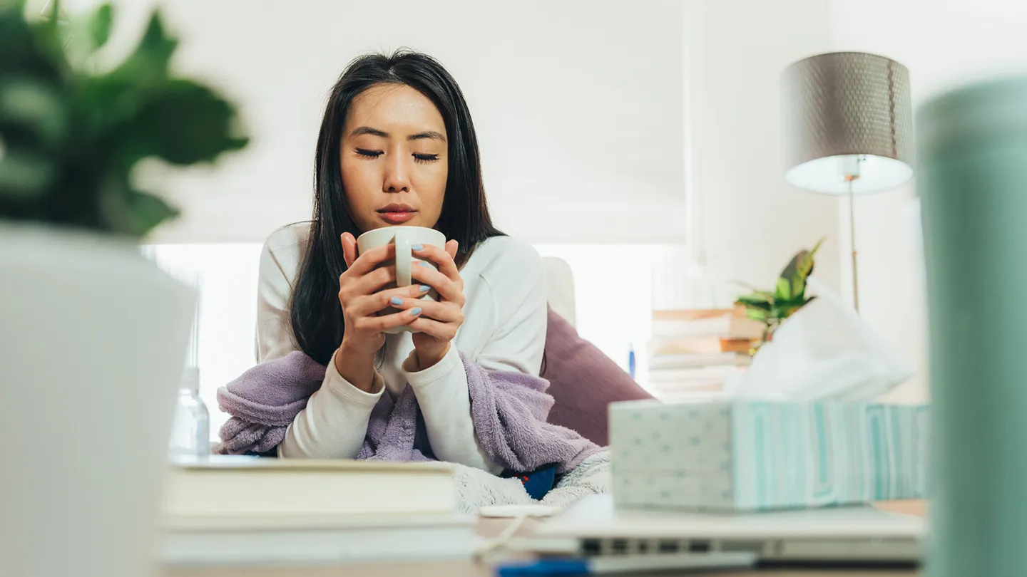 congested woman drinking tea
