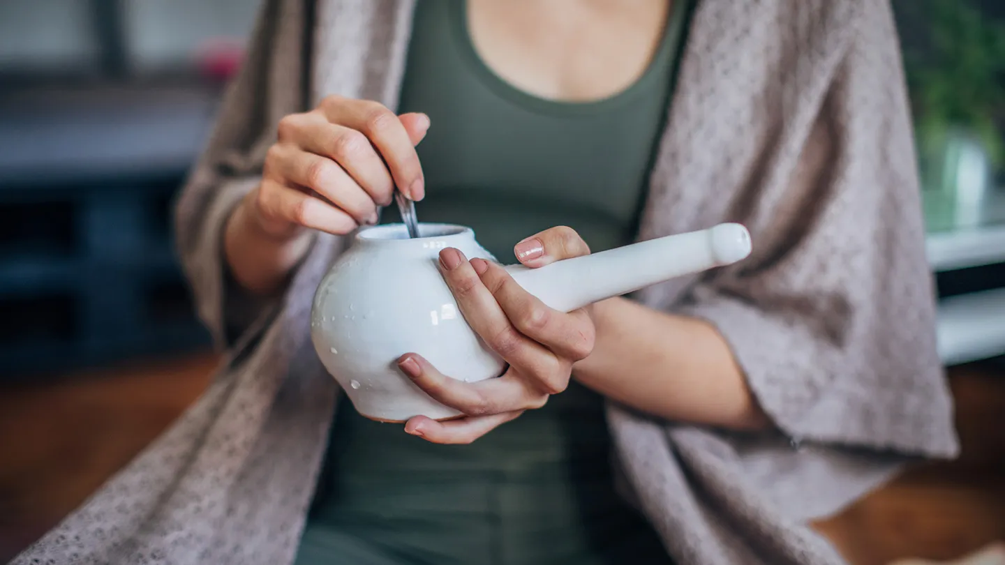 woman holding neti pot