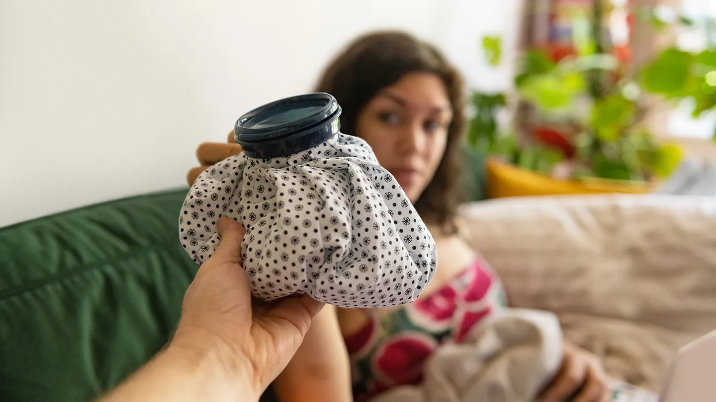 woman holding a warm compress