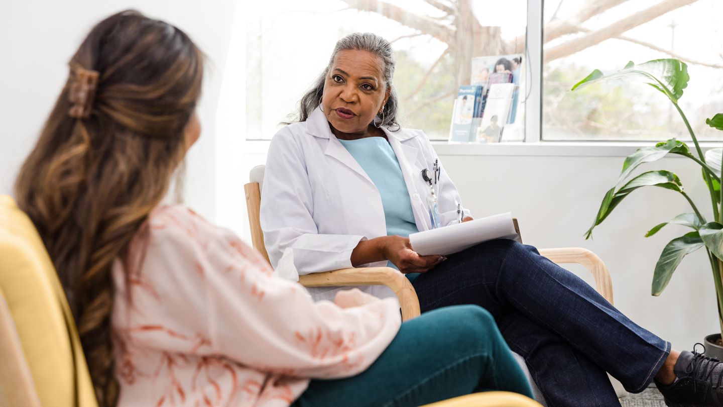 woman doctor talking with woman patient about clinical trials