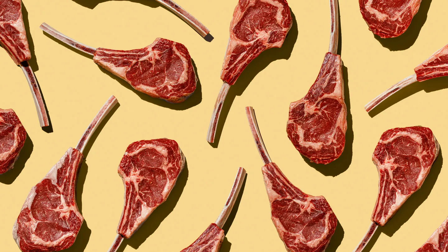 Pattern of Raw Tomahawk Steaks on yellow background