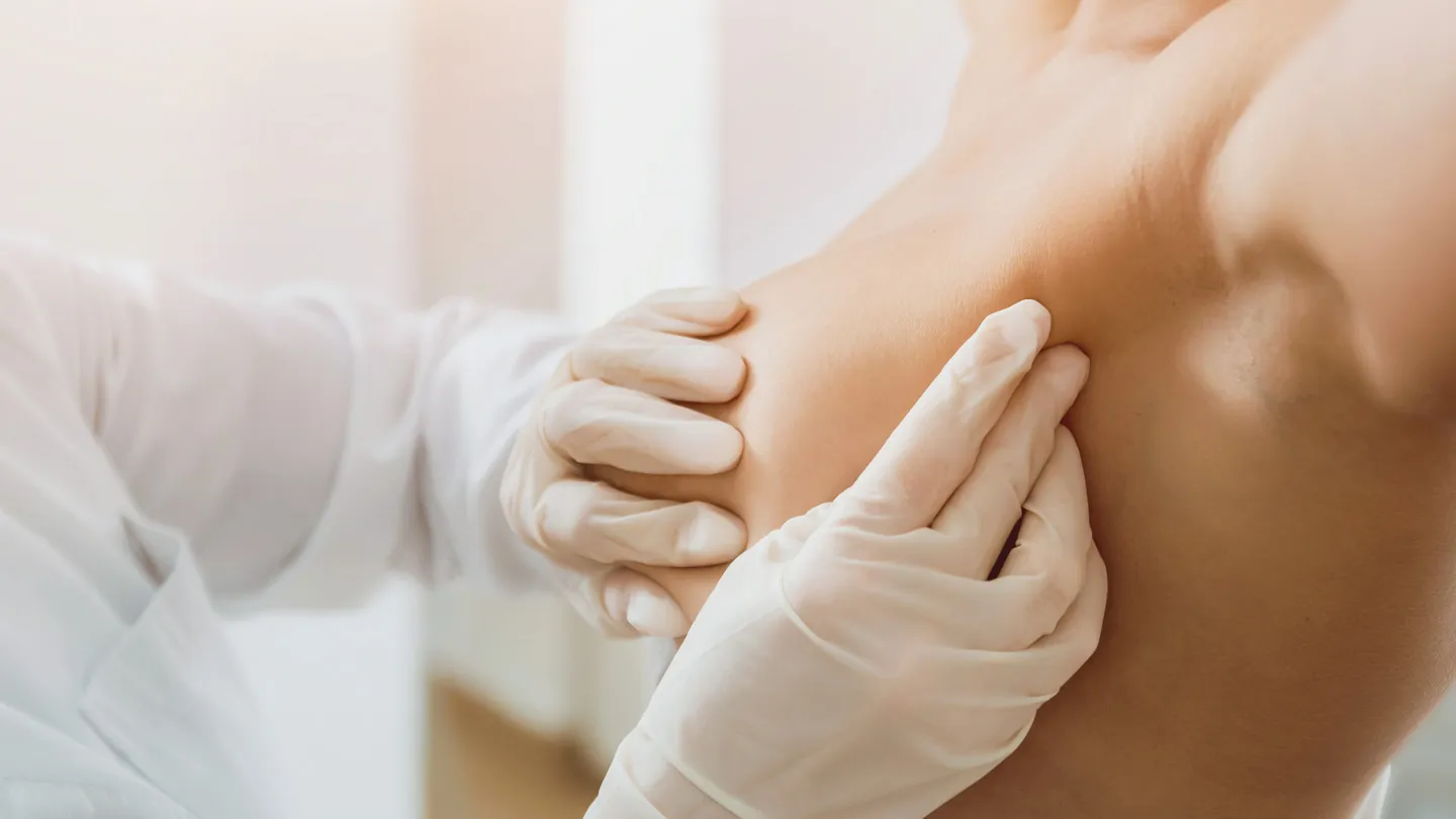 doctor doing a manual breast exam